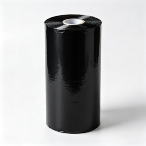 Black-silver reflective agricultural mulch film roll partially unrolled on a natural green grass background. The image shows both the glossy black and reflective silver sides of the mulch film, demonstrating its dual-function design. This farm mulch film is used for weed control, pest repelling, and enhancing light reflection for crop growth, suitable for outdoor farm applications.