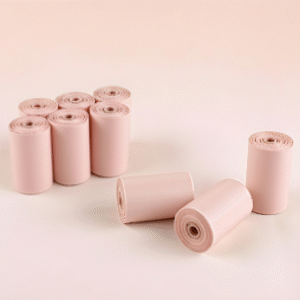 Light pink biodegradable pet waste bag rolls, multiple rolls neatly arranged on a light background, highlighting the product's soft color and environmentally friendly properties.