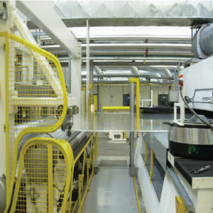 A roll of transparent, glossy biodegradable plastic film unfurled on a flat surface, representing eco-friendly packaging material.