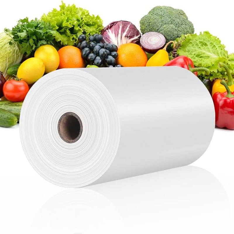 White biodegradable fruit and vegetable bags are placed in front of colorful fruits and vegetables, highlighting the pure appearance and environmental protection of the products.