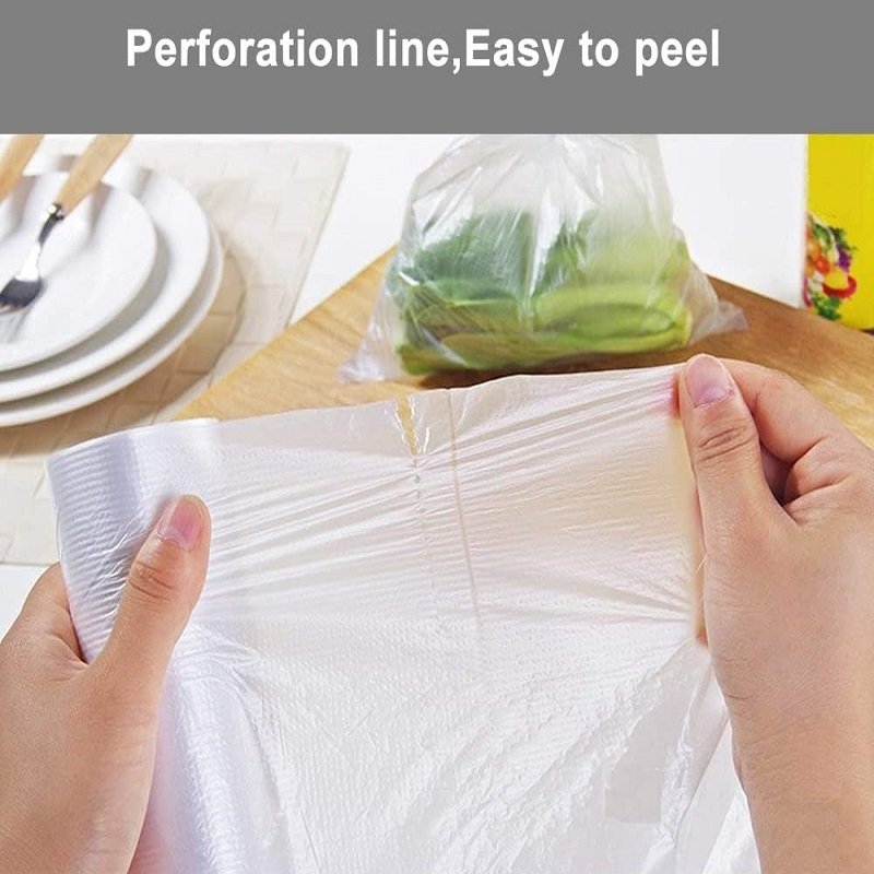 Hands are taking a biodegradable bag of fruits and vegetables out of the packaging. There are bags of vegetables and cutlery in the background, reflecting the convenience of product access and kitchen usage.