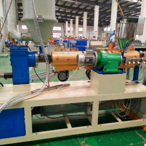 A large factory workshop with green flooring, various blue and metallic machinery, and spacious layout, indicating an organized environment for plastic film or packaging material production.