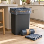 Heavy duty compostable trash bags in smoky navy film with a 13-gallon kitchen bin and roll