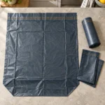 Flat 13 gallon compostable trash bag with reinforced gusset, folded bags and perforated roll
