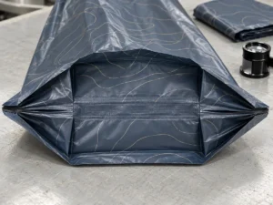 Reinforced layered bottom gusset on a heavy duty compostable trash bag