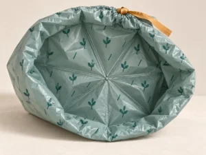 Eight-point star-seal bottom construction on a compostable drawstring bag