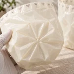 Gathered radial star seal on bottom of small compostable trash bag sample