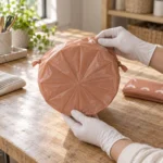 Gathered star-seal base detail on a small drawstring compostable bin liner